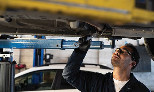 Mechanic working under a vehicle