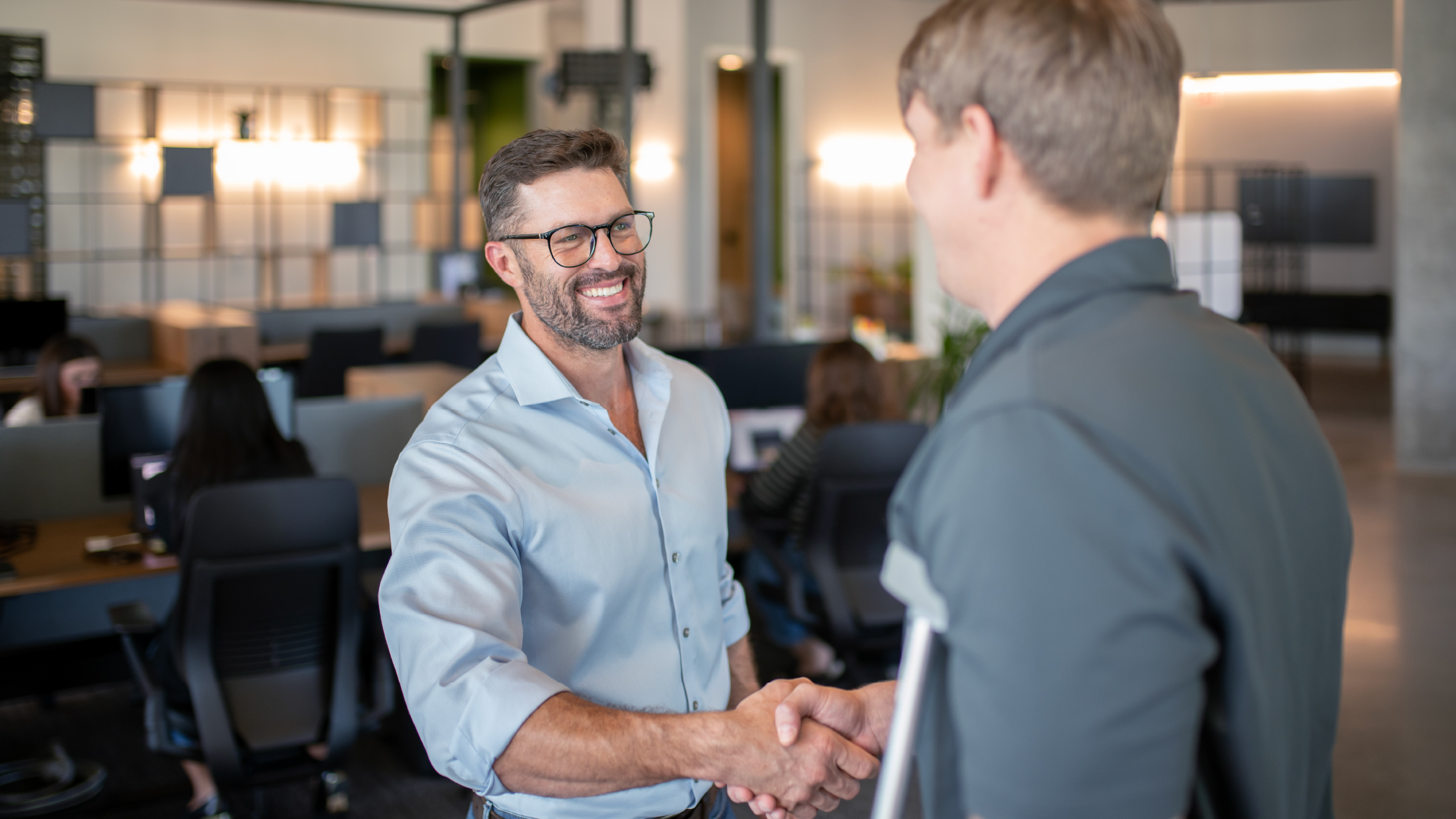 Men shaking hands as completing a deal.
